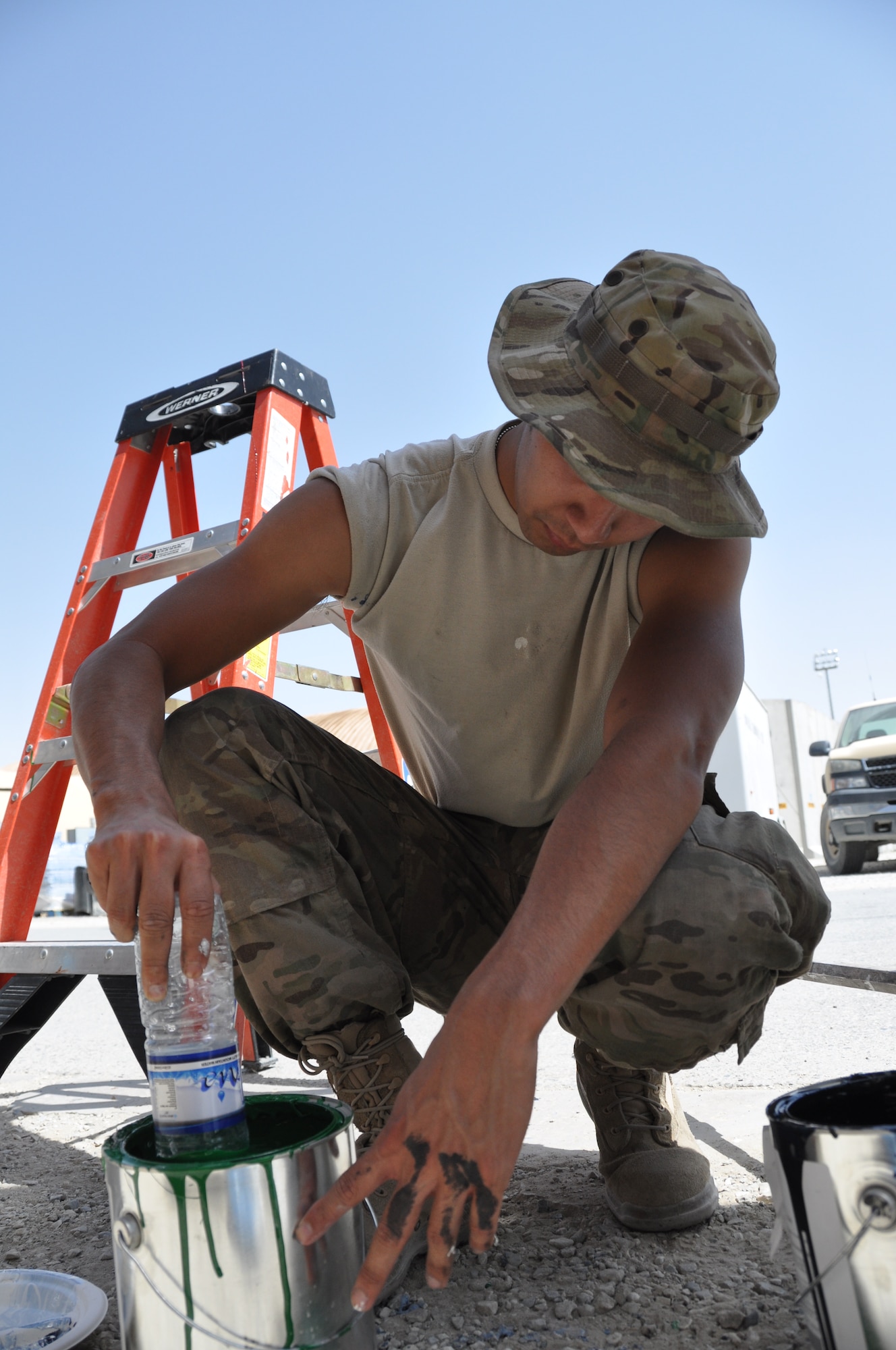 Airman 1st Class Eli Hixson, 455th Expeditionary Aerial Port Squadron air transportation passenger service agent, assists during a mural painting that depicts the bonds, unity, respect, trust, strength and the will to protect on the walls on Bagram Airfield, Afghanistan, Aug. 30, 2013. “This mural was intended to signify our growing efforts to help the Afghan military and government obtain the necessary fundamentals to begin their process in bringing not only their own country together, but to bring the U.S. and Afghanistan nations together,” said Hixson, deployed from McGuire AFB, N.J., and is a native of Laramie, Wyo. “It is also a symbol of what our fallen Soldiers, Airmen, Sailors and Marines have sacrificed and fought for in hopes that with our efforts, another nation can learn and become one with itself.” (U.S. Air Force photo/Tech. Sgt. Rob Hazelett)	