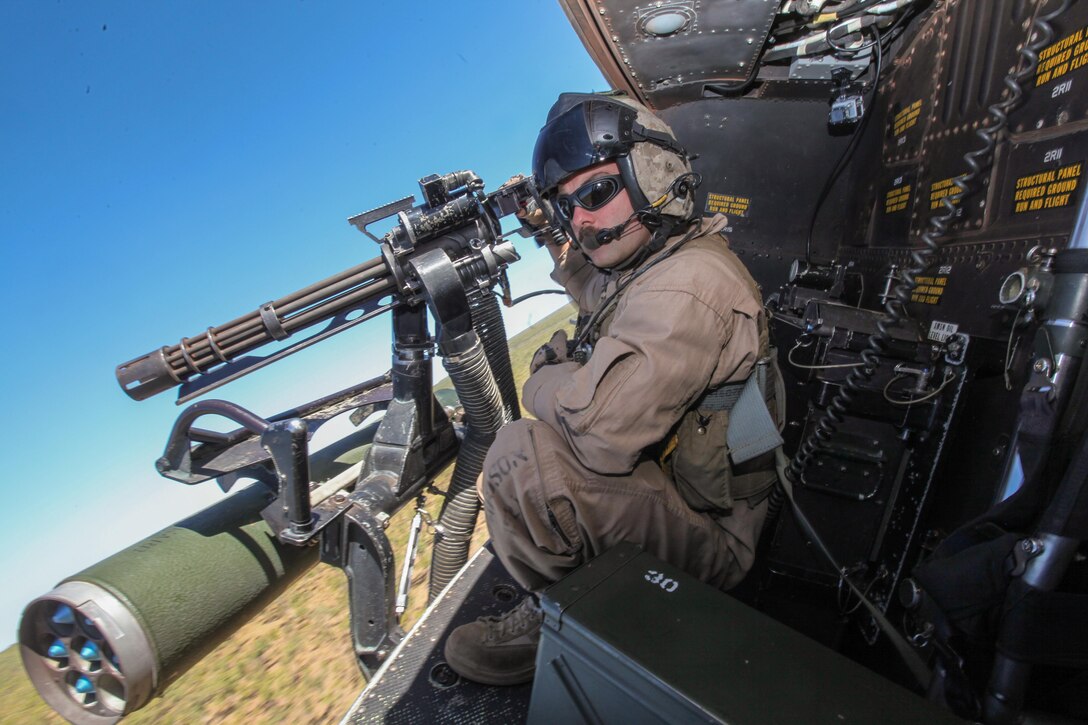 Sergeant Brian D. Richardson, a 29-year-old crew chief for Marine Medium Tiltrotor Squadron 265 (Reinforced), 31st Marine Expeditionary Unit, and a native of Leesburg, Fla., searches for targets aboard a UH-1Y Venom helicopter during live-fire training as part of Exercise Koolendong 13 here, Sept. 2. Three Venom helicopters and four MV-22 Osprey aircraft are operating from an expeditionary airfield 300 miles inland from the Port of Darwin, supporting the battalion-sized element conducting the exercise. Koolendong demonstrates the operational reach of the 31st MEU. Also participating in the exercise is the Marine Rotational Force – Darwin and soldiers of the 5th Royal Australian Regiment. The 31st MEU brings what it needs to sustain itself to accomplish the mission or to pave the way for follow-on forces. The 31st MEU is the Marine Corps' force in readiness for the Asia-Pacific region and the only continuously forward-deployed MEU. 