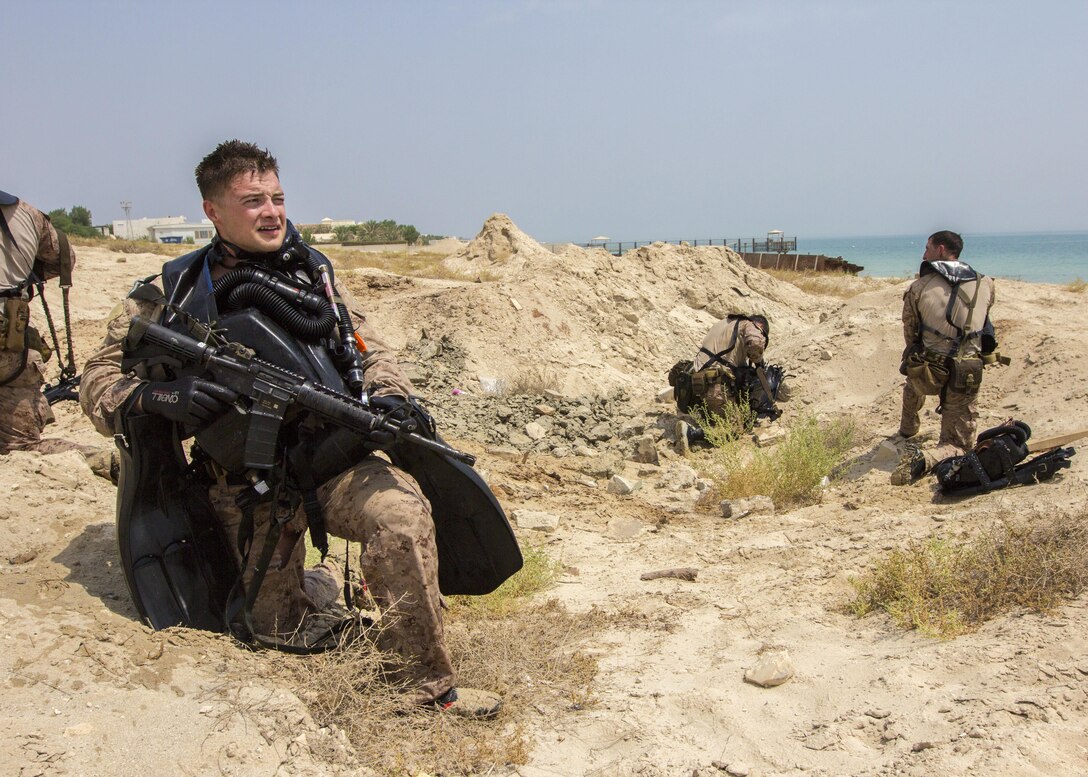 A U.S. Marine assigned to Force Reconnaissance Platoon, Maritime Raid Force, 26th Marine Expeditionary Unit (MEU), provides security while his teammates take dive gear off while conducting an amphibious insertion onto a beach in the U.S. 5th Fleet area of responsibility, Sept. 1, 2013. The 26th MEU is a Marine Air-Ground Task Force forward-deployed to the U.S. 5th Fleet area of responsibility aboard the Kearsarge Amphibious Ready Group serving as a sea-based, expeditionary crisis response force capable of conducting amphibious operations across the full range of military operations. (U.S. Marine Corps photo by Sgt. Christopher Q. Stone, 26th MEU Combat Camera/Released)