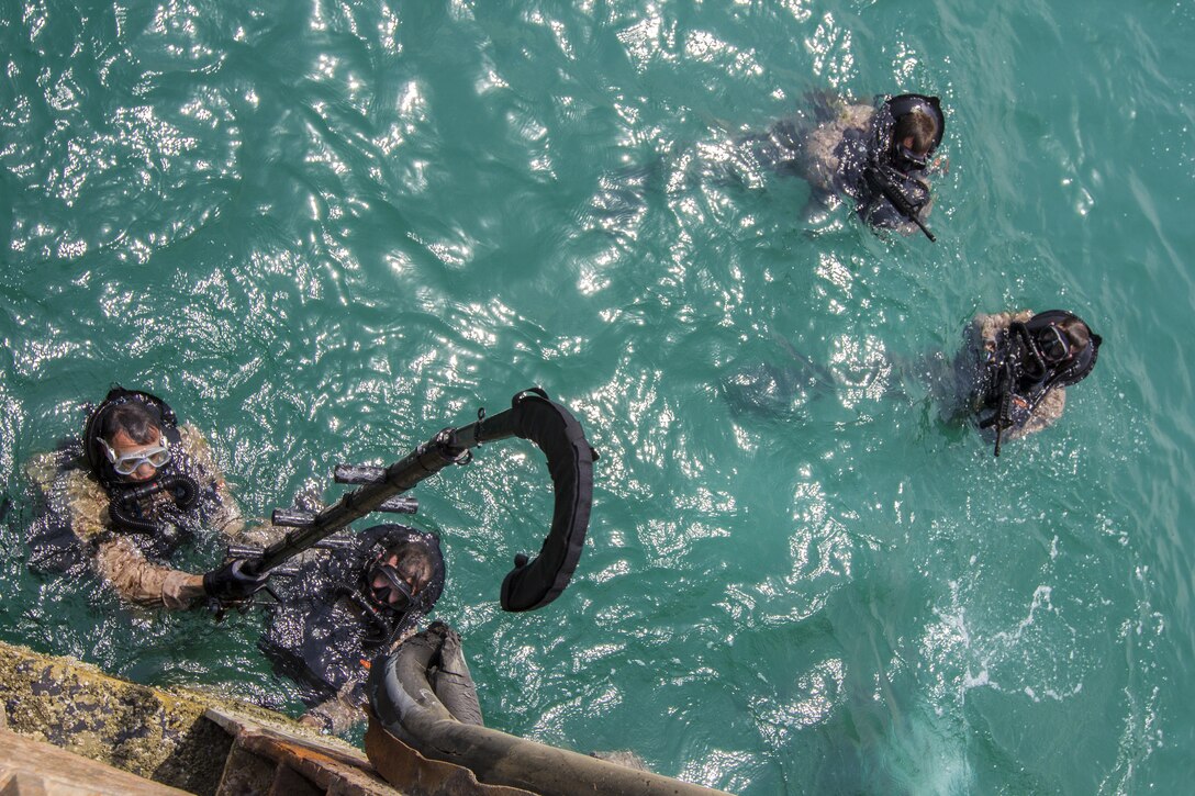 U.S. Marines assigned to Force Reconnaissance Platoon, Maritime Raid Force, 26th Marine Expeditionary Unit (MEU), prepare to hook and climb while conducting an amphibious insertion onto maritime infrastructure while training foreign Marines in the U.S. 5th Fleet area of responsibility, Sept. 1, 2013. The 26th MEU is a Marine Air-Ground Task Force forward-deployed to the U.S. 5th Fleet area of responsibility aboard the Kearsarge Amphibious Ready Group serving as a sea-based, expeditionary crisis response force capable of conducting amphibious operations across the full range of military operations. (U.S. Marine Corps photo by Sgt. Christopher Q. Stone, 26th MEU Combat Camera/Released)

