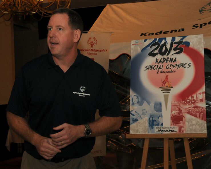 U.S. Air Force Brig. Gen. James Hecker, 18th Wing commander, unveils this year’s Kadena Special Olympics poster at the KSO pep rally on Kadena Air Base, Aug. 29, 2013. KSO is an annual event hosted by Kadena where the special needs athletes and artists are brought on base to compete is a variety of different sports and events. (U.S. Air Force photo by Staff Sgt. Laszlo Babocsi)