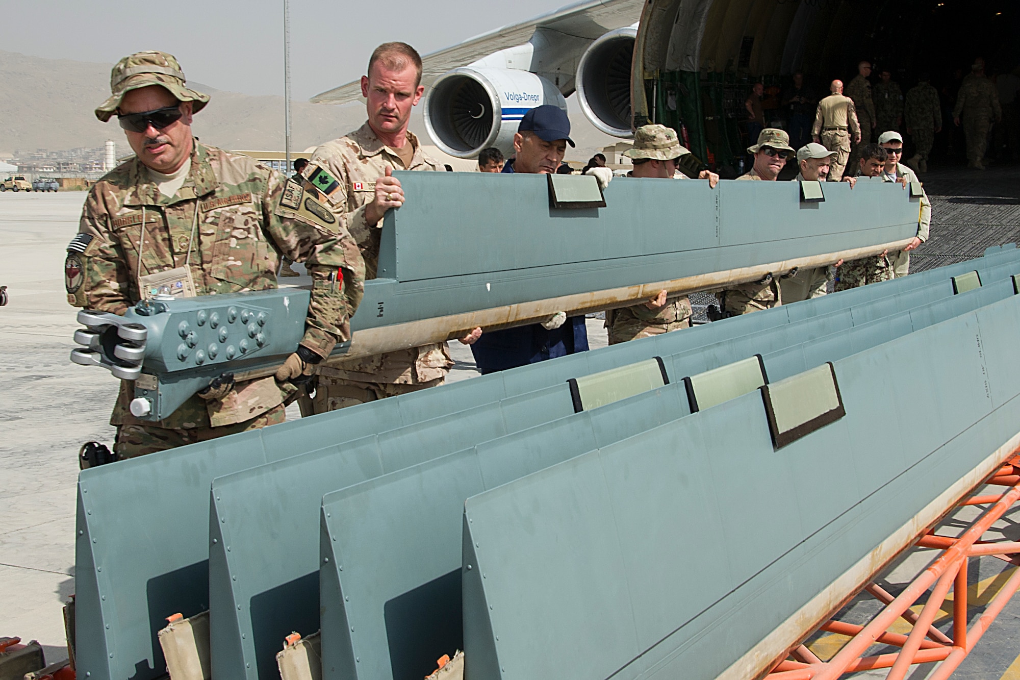 Coalition members work together to move an Mi-17 rotor out of a Russian Antonov An-124, Sept. 1 at Kabul International Airport Afghanistan. The rotors belong to one of three new Mi-17 helicopters transported to KAIA, as part of Project 12 which will add 12 new helicopters to the Afghan Air Force. (U.S. Air Force Photo/RCAF Sgt. Robert Mellin)
