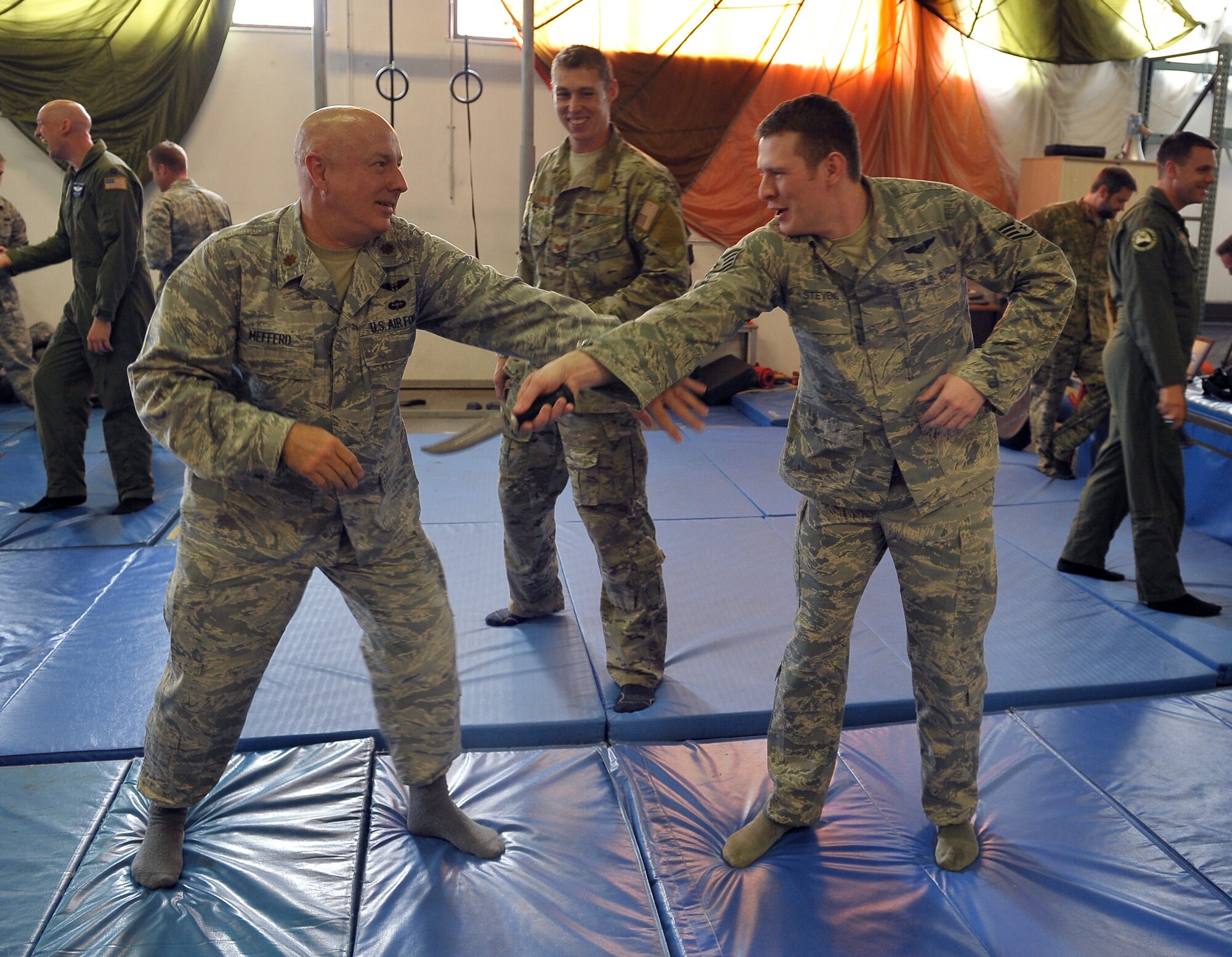 Staff Sgt. Josh Krape, 86th Operations Support Squadron survival, evasion, resistance, and escape specialist, instructs Airmen on how to disarm a hostel threat during their survival, evasion, resistance and escape refresher course, Aug. 13, 2013, Ramstein Air Base, Germany. Aircrews are required to conduct SERE training every three years to stay current and in case they are stranded or lost in a downed aircraft. (U.S. Air Force photo/Airman Dymekre Allen)