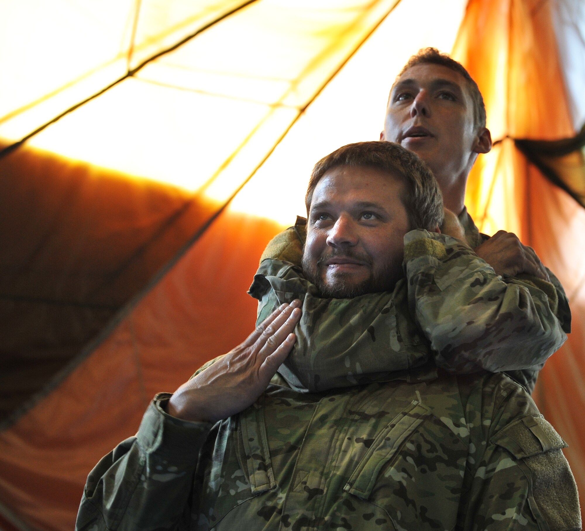 Staff Sgt. Josh Krape, 86th Operations Support Squadron survival, evasion, resistance, and escape specialist, demonstrates proper blood choke techniques during their survival, evasion, resistance and escape refresher course, Aug. 13, 2013, Ramstein Air Base, Germany. Aircrews are required to conduct SERE training every three years to stay current and in case they are stranded or lost in a downed aircraft. (U.S. Air Force photo/Airman Dymekre Allen)