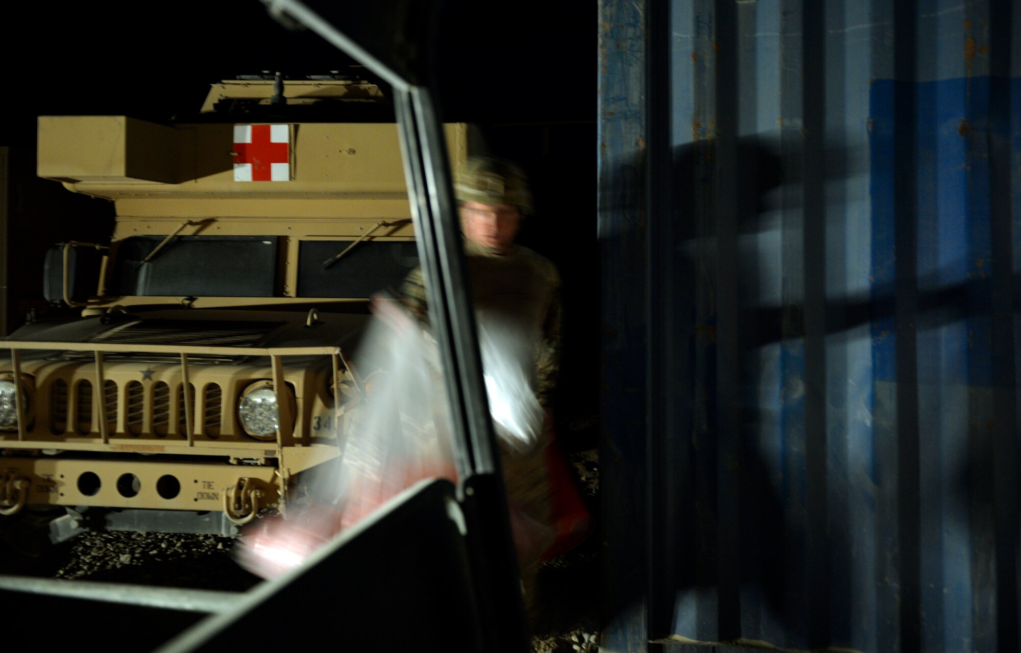 Staff Sgt. Chad Whitehead, carries bio waste from a storage container to his vehicle to transport to an incinerator on the edge of Forward Operating Base Ghazni August 25, 2013. Whitehead is a Forward Surgical Team emergency room technician and NCO in charge of Mortuary affairs here.  He is deployed from Keesler Air Force Base, Miss., and a native of Texarkana, Texas. (U.S. Air Force photo/ Staff Sgt. Stephenie Wade)