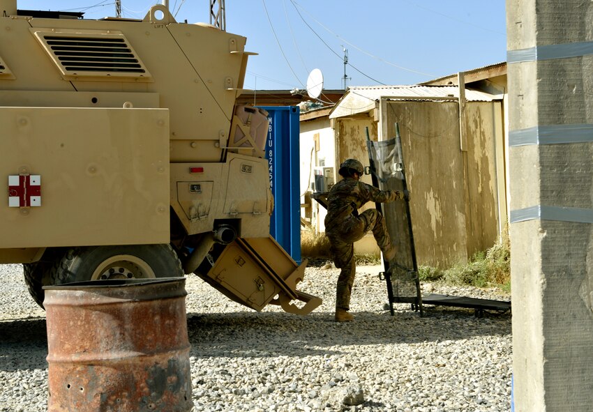 Staff Sgt. Adriana Almeida, a Forward Surgical Team scrub technician, prepares a litter to load onto a Mine-Resistant Ambush Protected prior to a training scenario on Forward Operation Base Ghazni, Afghanistan. She is deployed from Eglin Air Force Base, Fla. (U.S. Air Force photo/ Staff Sgt. Stephenie Wade)