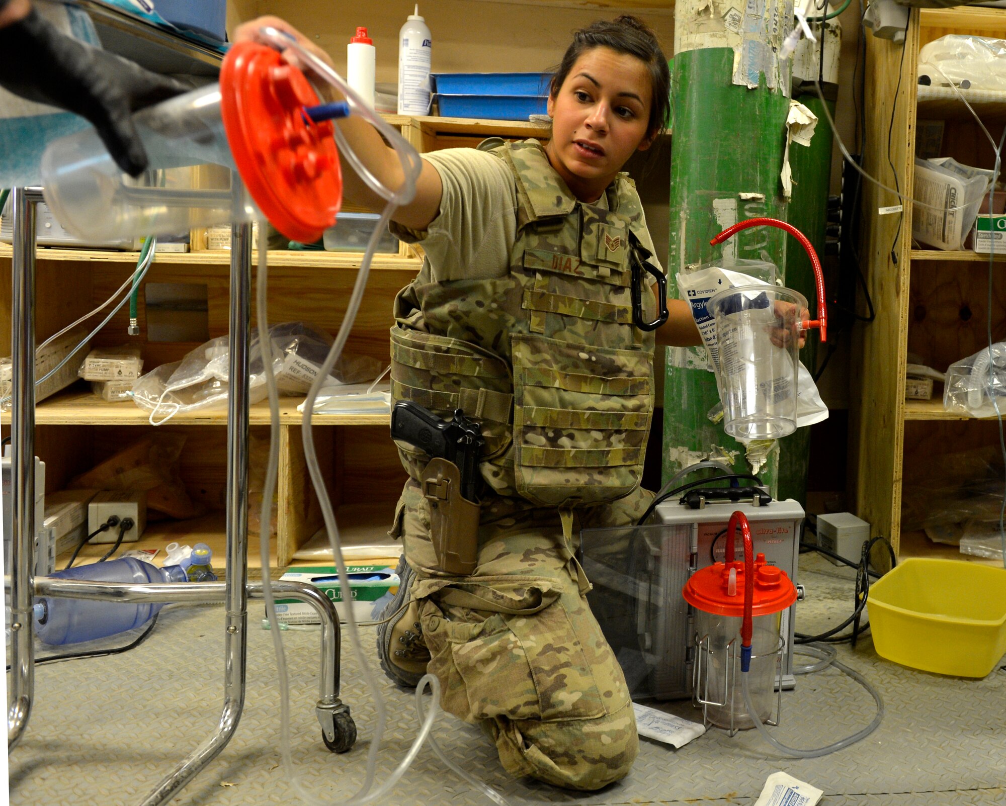 Staff Sgt. Gabriel Diaz, Forward Surgical Team Emergency Room technician, prepares suction equipment for an incoming patient on Forward Operating Base Ghazni, August 25, 2013. She is in charge of preparing and treating patients in the ER. Diaz is deployed from Travis Air Force Base, Calif. (U.S. Air Force photo/ Staff Sgt. Stephenie Wade)