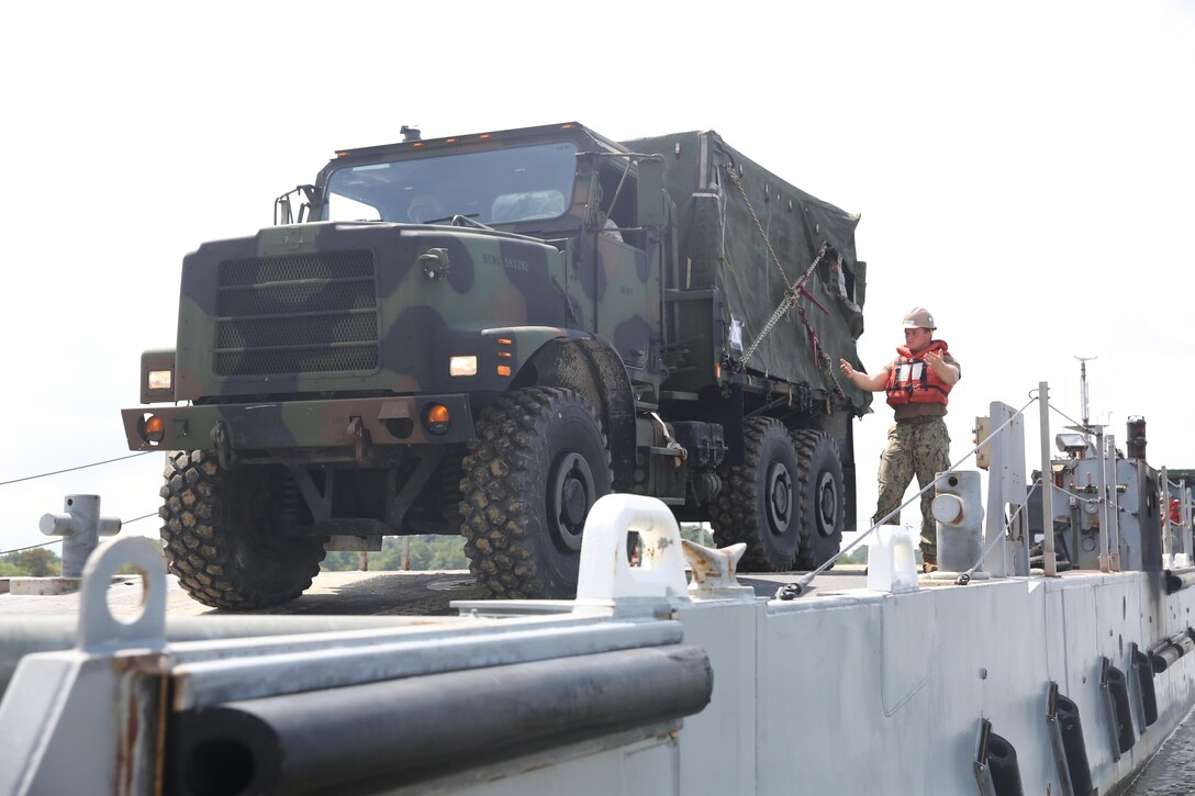 Service members with Combat Logistics Battalion 24, 2nd Marine Logistics and the Navy’s Beach Departure Team 5 conduct onload operations during a Defense Support of Civil Authorities, or DSCA, training exercise, Naval Amphibious Base Little Creek, Va., Aug. 21, 2013. The battalion practiced DSCA operations during a three-day exercise in preparation for possible humanitarian missions during natural disasters.