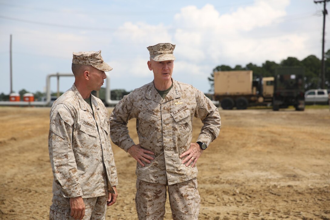 Lt. Gen. Richard T. Tryon (center), the commanding general of U.S. Marine Corps Forces Command and U.S. Marine Forces Europe, speaks with Lt. Col. Matthew A. Dumenigo (left), the commanding officer of Combat Logistics Battalion 24, 2nd Marine Logistics Group, during a Defense Support of Civil Authorities, or DSCA, training exercise, aboard Naval Amphibious Base Little Creek, Va., Aug. 21, 2013. The battalion practiced DSCA operations during a three-day exercise in preparation for possible humanitarian missions during natural disasters. 