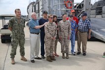 Marines with Combat Logistics Battalion 24, 2nd Marine Logistics Group and a sailor with the Navy’s Assault Craft Unit 4 pose for a photograph with World War II veterans and family during a Defense Support of Civil Authorities, or DSCA, training exercise, aboard Naval Amphibious Base Little Creek, Va., Aug. 21, 2013. The three-day operation provided CLB-24 with an opportunity to perform loading and offloading procedures with Navy units it would work alongside of during a DSCA event. 