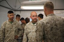 Col. Paul F. Bertholf (center), the commanding officer of the Marine Corps Combat Service Support Schools, speaks with a Marine with 2nd Supply Battalion, Combat Logistics Regiment 25, 2nd Marine Logistics Group about a cooperative field exercise between the battalion and the Marine Corps’ Supply School aboard Camp Lejeune, N.C., Aug. 27, 2013. The operation gave students from the Ground Supply Officer Course an opportunity to learn from Marines already serving in the Fleet Marine Force with a supply unit in a field environment. 