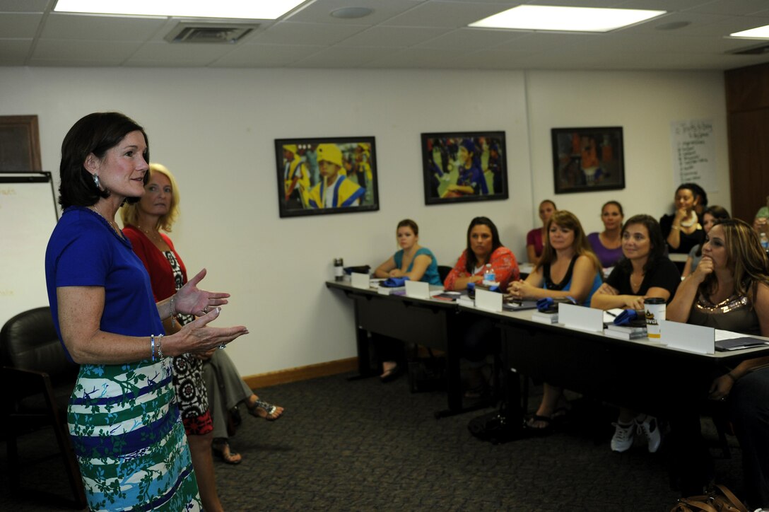 Betty Welsh, wife of Air Force Chief of Staff Gen. Mark A. Welsh III, and Athena Cody, wife of Chief Master Sgt. of the Air Force James Cody, spoke at the Key Spouse orientation brief at the Airman and Family Readiness Center Aug. 22, 2013, at Kadena Air Base, Japan. The AFRC hosted a key spouse forum where Betty and Athena learned about various efforts and programs key spouses of Kadena have implemented in order to keep Air Force spouses informed and taken care of during stressful times like deployments and permanent change of station seasons. (U.S. Air Force photo/Airman 1st Class Hailey R. Davis)