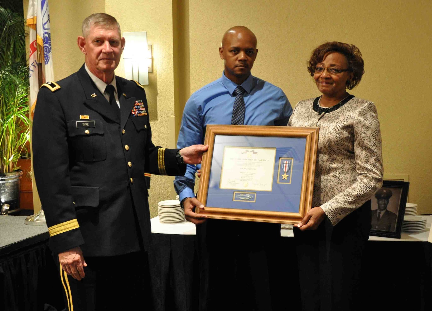 Florida National Guard Assistant Adjutant General for Army Maj. Gen. James Tyre presents a posthumous Silver Star award for Sgt. Matthew Carter to Carter's wife Lorine and son Quinton during an Oct. 27 ceremony.
