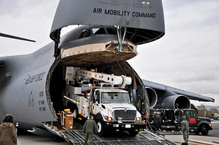 Air Force crews offload Southern California Edison power repair equipment from a C-5 Galaxy on Stewart Air National Guard Base in Newburgh, N.Y., Nov. 1, 2012. The Defense Department initiated the airlift operation to aid recovery efforts in Hurricane Sandy's aftermath.