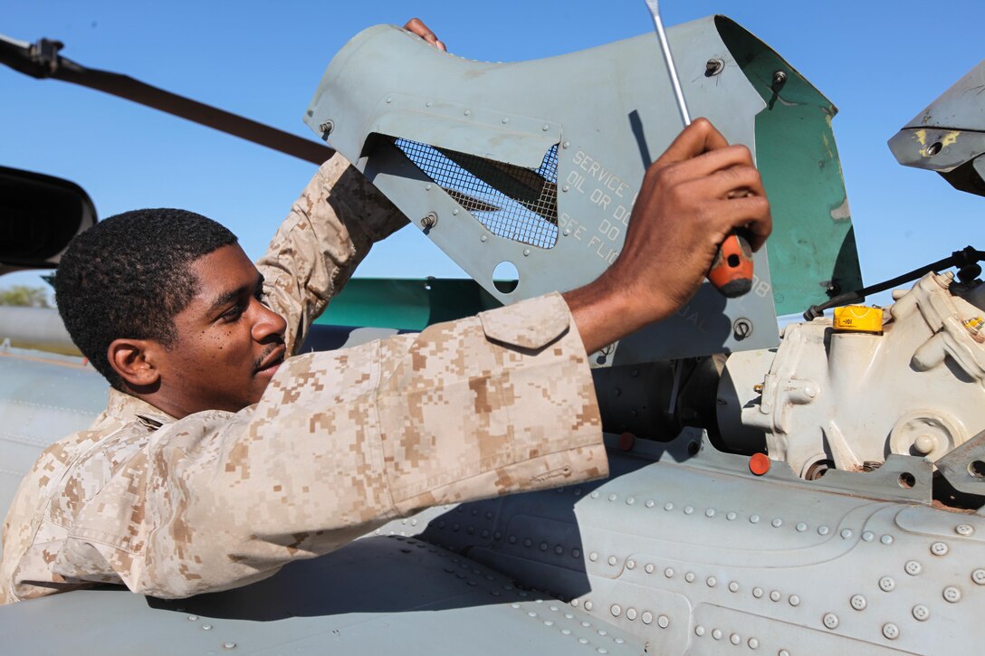 Sergeant Jeffrey O. Burton, a 25-year-old avionics non-commissioned officer in charge for Marine Light Attack Squadron 369, currently attached to Marine Medium Tiltrotor Squadron 265 (Reinforced), 31st Marine Expeditionary Unit, and a native of Goose Creek, S.C., removes a panel from the tail of a UH-1Y Venom helicopter during maintenance here, Sept. 3. The helicopters are supporting the battalion-sized element currently conducting Exercise Koolendong 13. Koolendong demonstrates the operational reach of the 31st MEU. Also participating in the exercise is the Marine Rotational Force – Darwin and soldiers of the 5th Royal Australian Regiment. The 31st MEU brings what it needs to sustain itself to accomplish the mission or to pave the way for follow-on forces. The 31st MEU is the Marine Corps' force in readiness for the Asia-Pacific region and the only continuously forward-deployed MEU. 