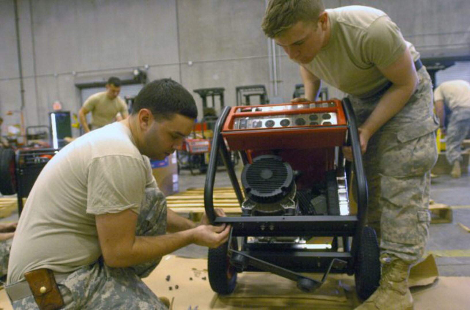 New York Army National Guard Spc. Christopher Miltner and Spc. David De La Mater prep a generator to be used at polling sites in areas affected by Hurricane Sandy.