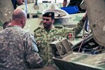 During their visit to Camp Tahreer, Kuwait, Sept. 25, 2012, U.S. soldiers were given an explanation on some of the mechanical differences between the vehicles used in the Kuwait National Guard.