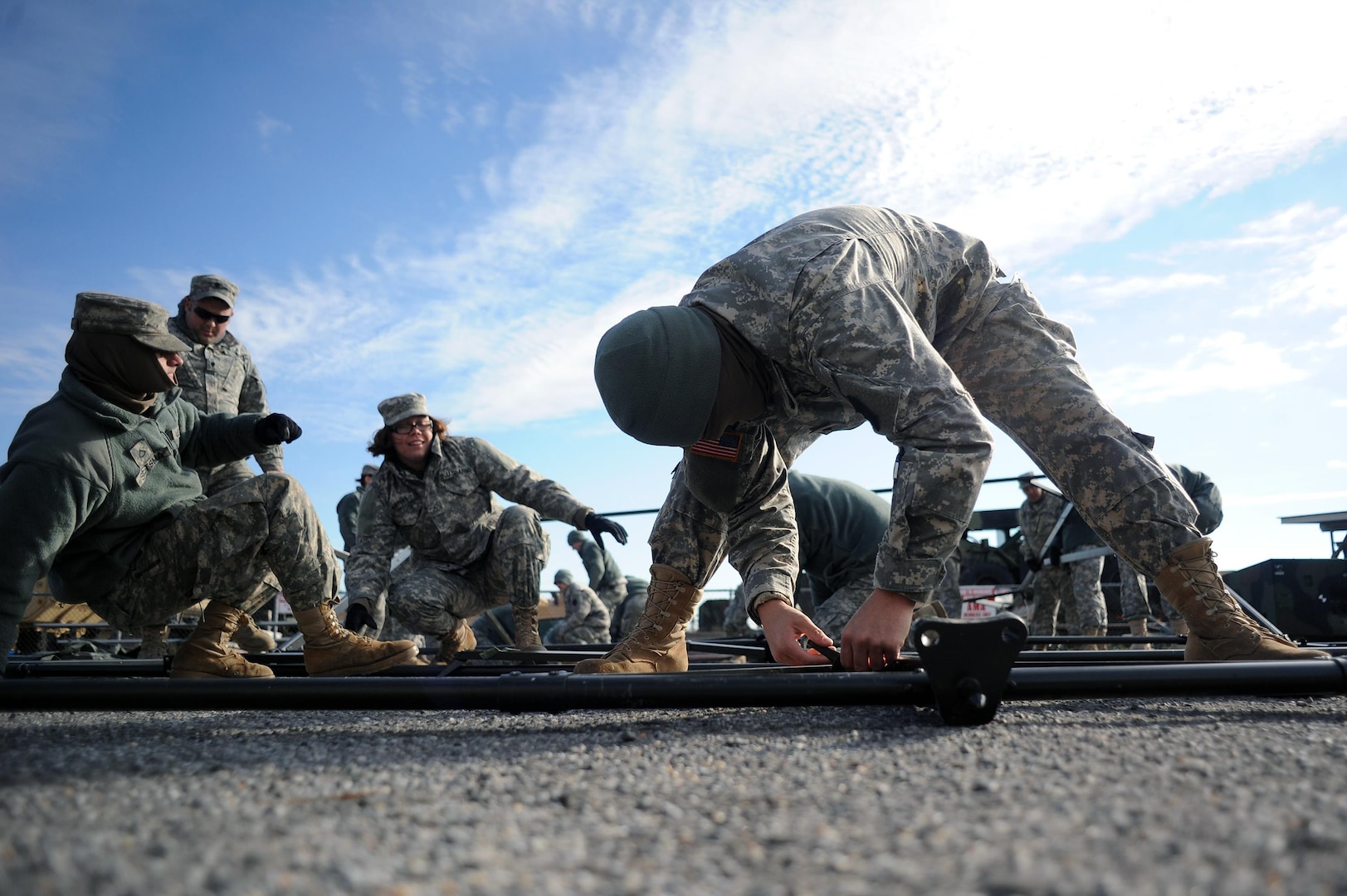 Spc. Christopher Mitzak, a mechanic with the Pennsylvania Army National Guard's Company A, 228th Brigade Support Battalion, works with other unit members to assemble the support structure of a maintenance tent at Floyd Bennett Field in Brooklyn, N.Y., Nov. 5, 2012.