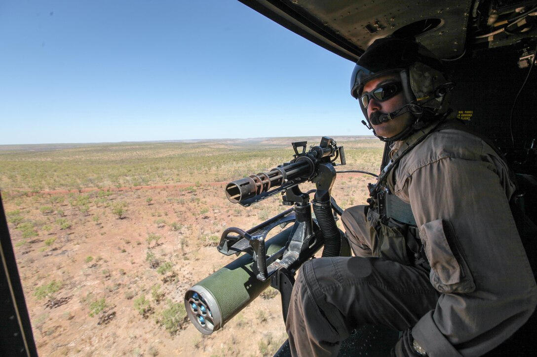 Sergeant Brian D. Richardson, a 29-year-old UH-1Y Venom helicopter crew chief for Marine Light Attack Squadron 369, currently attached to Marine Medium Tiltrotor Squadron 265 (Reinforced), 31st Marine Expeditionary Unit, and a native of Leesburg, Fla., searches for targets during a live-fire training flight here, Sept. 2. The helicopters are supporting the battalion-sized element currently conducting Exercise Koolendong 13. Koolendong demonstrates the operational reach of the 31st MEU. Also participating in the exercise is the Marine Rotational Force – Darwin and soldiers of the 5th Royal Australian Regiment. The 31st MEU brings what it needs to sustain itself to accomplish the mission or to pave the way for follow-on forces. The 31st MEU is the Marine Corps' force in readiness for the Asia-Pacific region and the only continuously forward-deployed MEU. 