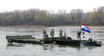 Soldiers from the 1438th Engineer Company of Macon, Mo., secure a piece of a bridge that has just unfolded in the river as part of a training exercise for Vigilant Guard.
