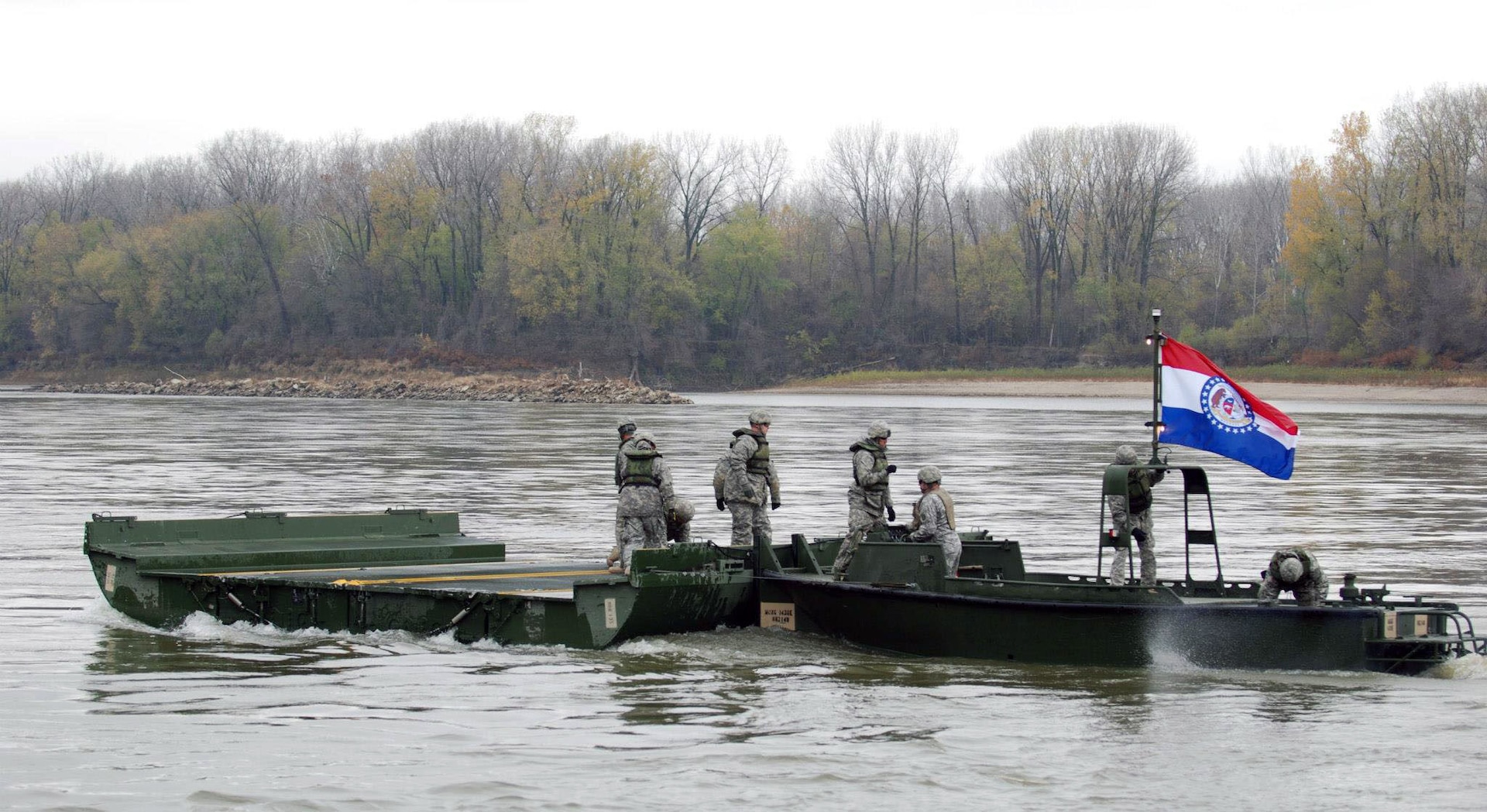 Soldiers from the 1438th Engineer Company of Macon, Mo., secure a piece of a bridge that has just unfolded in the river as part of a training exercise for Vigilant Guard.