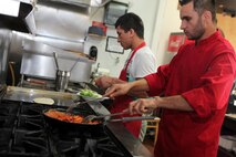Chef Mohamed Ajmal (right)  and assistant chef Waisulah Hayatullah, prepare traditional Afghanistan dishes at Naan and Kabob, Aug. 14. All the food at Naan and Kabob are made with traditional Afghanistani recipes and techniques. 