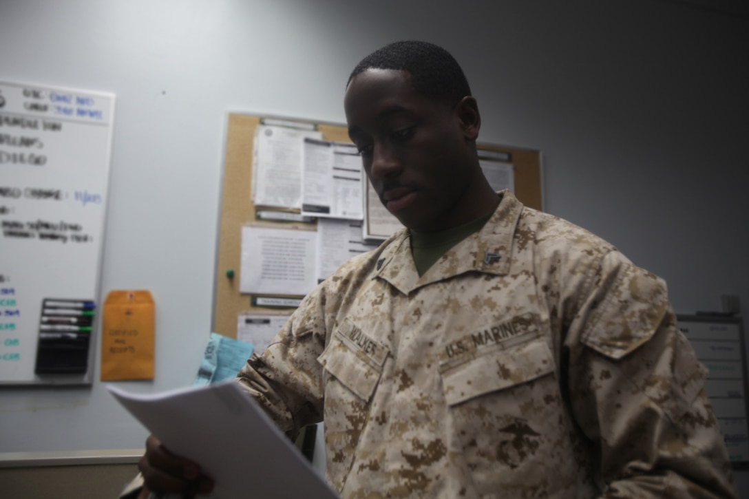 Corporal Jonathan Walker, a fiscal agent with Disbursing, Combat Logistics Regiment 17, 1st Marine Logistics Group, analyzes data aboard Camp Pendleton, Calif., Aug. 27, 2013. Marines in Disbursing support the war effort on multiple fronts, ranging from providing spending allowances to Marines during deployment to providing Marine Special Operations Command units pay to use for counterinsurgency operations. 