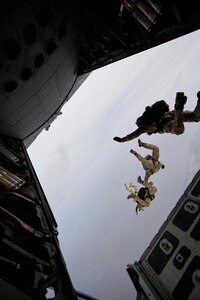 Members of the Alaska Air National Guard's 212th Rescue Squadron perform a free-fall jump over the Malemute Drop Zone, on the Joint Base Elmendorf-Richardson installation. Two pararescuemen used a similar jump to save a woman.