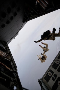 Members of the Alaska Air National Guard's 212th Rescue Squadron perform a free-fall jump over the Malemute Drop Zone, on the Joint Base Elmendorf-Richardson installation. Two pararescuemen used a similar jump to save a woman.