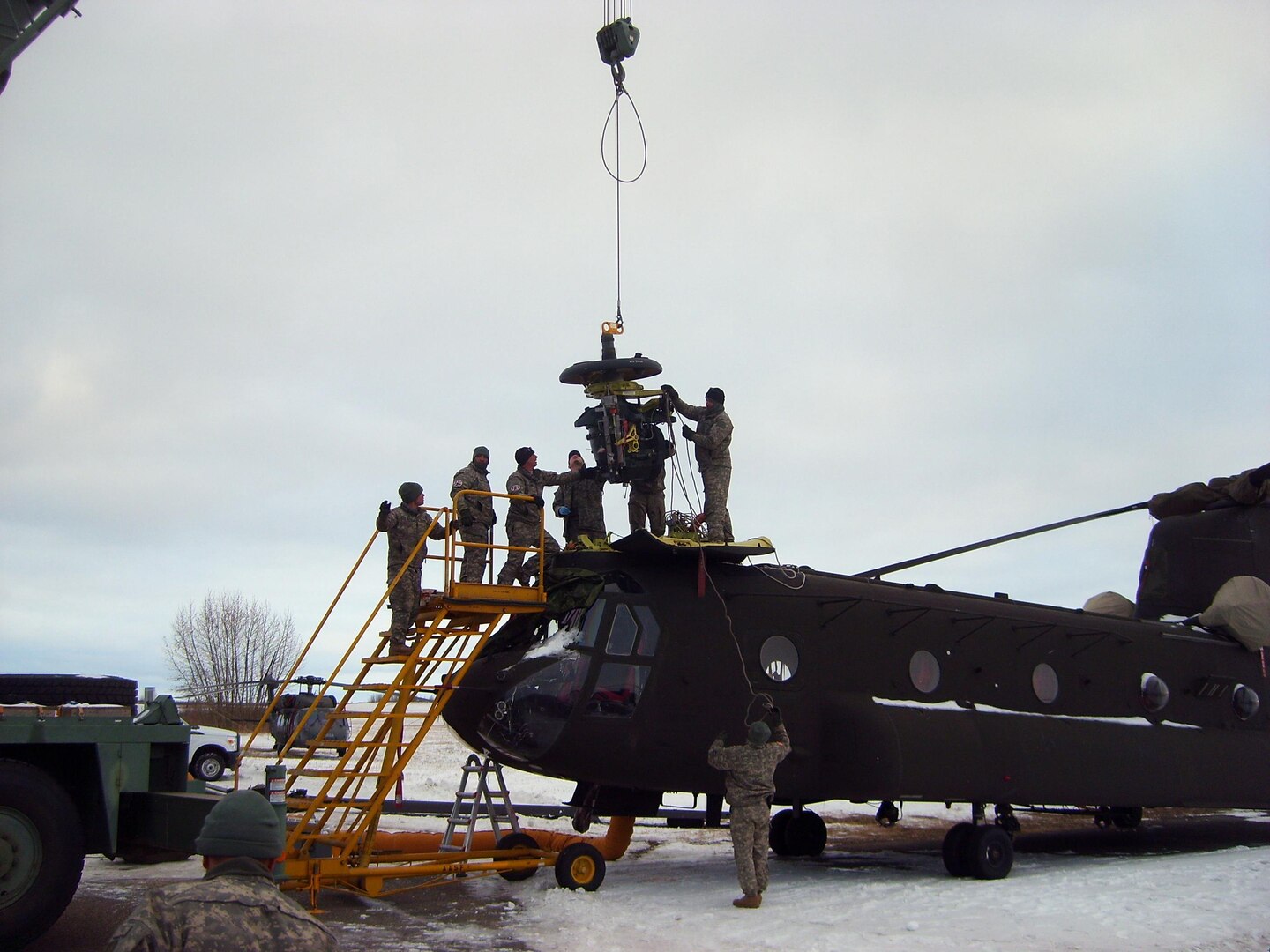 Colorado Army National Guard members replace a bad transmission in a CH-47 Chinook helicopter in below-freezing temperatures during operation Maple Resolve at the Canadian Manoeuver Training Center in Wainwright, Alberta Oct. 24, 2012.