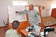 Army Capt. Terrannce McIntosh, standing, shows his Kazakh counterpart troop positions during Exercise Steppe Eagle 12, conducted in Kazakhstan in September 2012. Arizona and Kazakhstan have been partnered under the National Guard's State Partnership Program for 20 years.