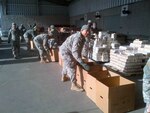 Soldiers from the New York Army National Guard's 369th Sustainment Brigade, the legendary "Harlem Hellfighters," prepare holiday meals at Manhattan's Jacob Javits Center for shipment and delivery to city distribution sites.