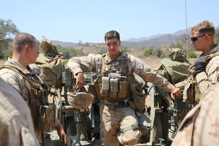 Sergeant Ryan Boyd, section chief, India Battery, 1st Battalion, 11th Marine Regiment, briefs his Marines on their performance during a 10-day artillery training exercise here, Aug. 23, 2013. Marines with the entire regiment conducted the live-fire training exercise from Aug. 19 through 28.