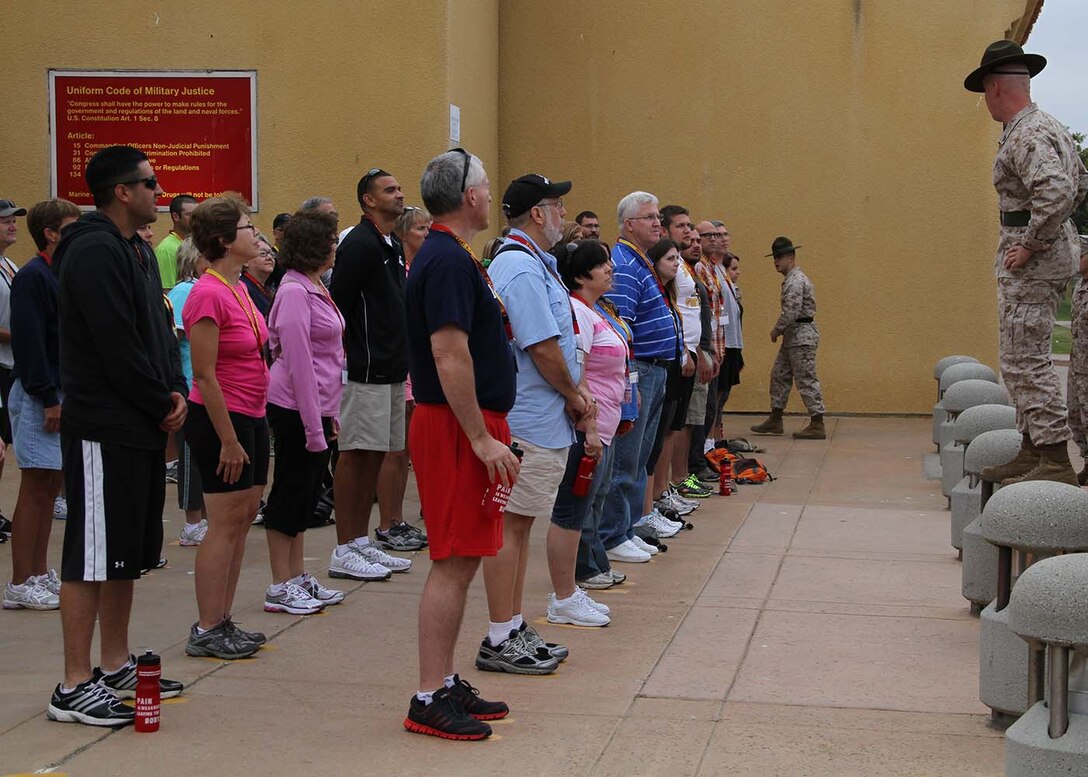 Educators from RS Des Moines and Indianapolis stand on the yellow footprints and await their orders aboard Marine Corps Recruit Depot San Diego, Calif., during the 2013 Educators Workshop on August 6.