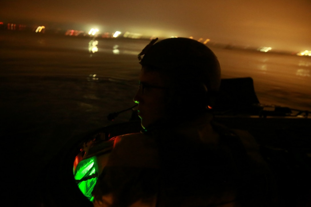 Private First Class David Lee, amphibious assault vehicle driver, Charlie Company, 3rd Assault Amphibian Battalion, and native of San Clemente, Calif., drives an amphibious assault vehicle toward their objective during a nighttime beach landing here, Aug. 25, 2013. The nighttime landing was the first stage in the four-day training exercise where the Marines honed their amphibious and combat capabilities. The Marines performed the exercise in preparation for their upcoming deployment to Okinawa, Japan, where they will support joint operations in the Pacific.
