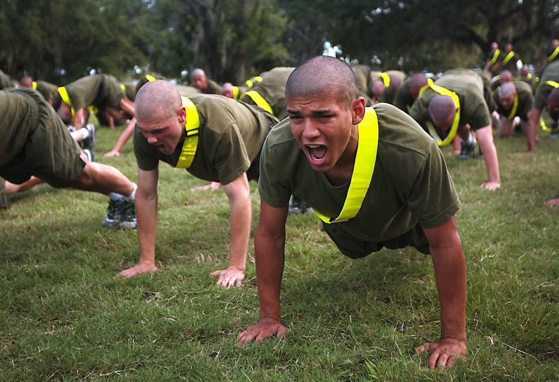 Recruits perform various exercises meant to strengthen their bodies to meet the Marine Corps’ high physical fitness standards.