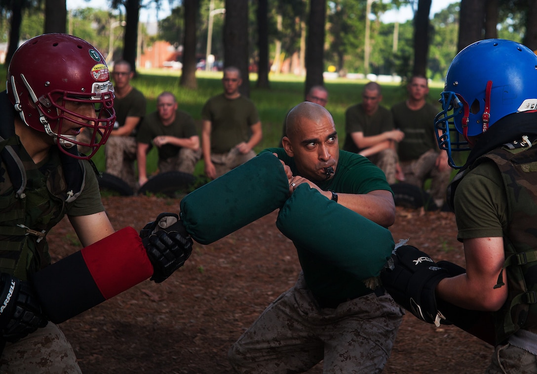 Sgt. Roberto Martinez, 33, a martial arts instructor on Parris Island, initiates a pugil stick match during training July 8, 2013, on Parris Island, S.C. Each recruit participated in two 15-second matches. Recruits train with pugil sticks, which represent rifles with attached bayonets, to simulate close-range encounter with an enemy. Bayonet training, along with other hand-to-hand fighting skills, is encompassed in the Marine Corps Martial Arts Program, which contributes to the mental, character and physical development of Marines. Approximately 20,000 recruits come to Parris Island annually for the chance to become United States Marines by enduring 13 weeks of rigorous, transformative training. Parris Island is home to entry-level enlisted training for 50 percent of males and 100 percent of for females in the Marine Corps. Martinez is from West Covina, Calif. Hotel Company is scheduled to graduate Sept. 20, 2013. (Photo by Lance Cpl. David Bessey)
