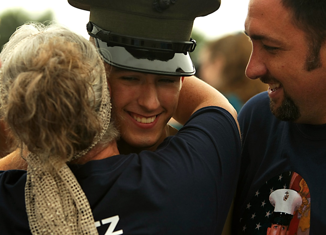 A Marine greets family and friends following his graduation ceremony.