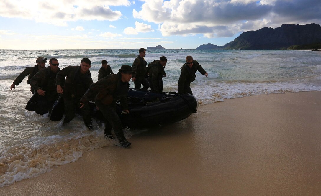 Reconnaissance Marines with Battalion Landing Team 1/4, 13th Marine Expeditionary Unit, drag ashore one of three Combat Rubber Reconnaissance Craft (CRRC’s) on Bellows Beach on the Island of Oahu, Hawaii, during sustainment training Aug. 31, 2013. The three teams left the USS Boxer on the CRRC’s just after sunrise with the objective of securing an area of Bellows Beach thus allowing Landing Craft Air Cushion’s (LCAC’s) to land and transport military vehicles ashore. The Marines and Sailors with 13th MEU will deploy for several months in support of theater requirements of Geographic Combatant Commanders.  (USMC Photo by SSgt. Matt Orr/Released)