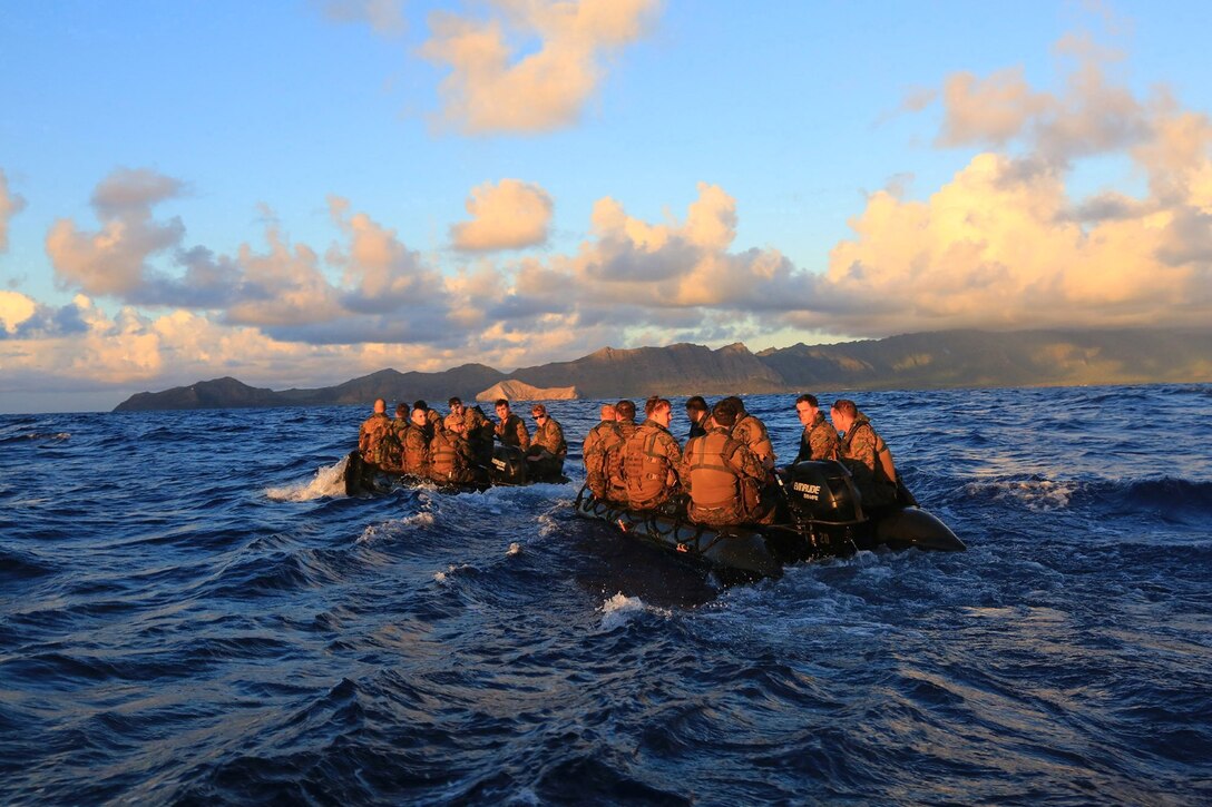 Reconnaissance Platoon Marines with Battalion Landing Team 1/4, 13th Marine Expeditionary Unit, head toward Bellows Beach on the Island of Oahu, Hawaii, during sustainment training Aug. 31, 2013. The Marines left the USS Boxer on Combat Rubber Reconnaissance Craft (CRRC) just after sunrise with the objective of securing an area of Bellows Beach, allowing Landing Craft Air Cushion’s (LCAC’s) to land and transport military vehicles ashore. The Marines and Sailors with 13th MEU will deploy for several months in support of theater requirements of Geographic Combatant Commanders.  (USMC Photo by SSgt. Matt Orr/Released)