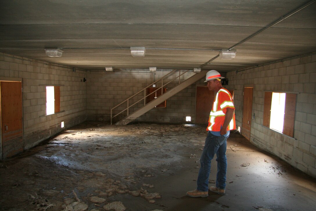 Justin Gay, a project manager with the U.S. Army Corps of Engineers Los Angeles district’s Fort Irwin Resident Office, assesses damages at the Medina Jabal Training Area. The debris flow consisting of mud and rock filled the bottom floor with roughly three feet of debris. 