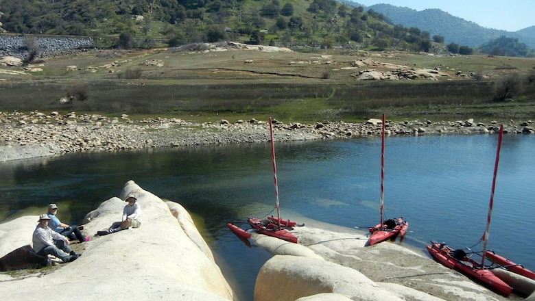 Members of the Sierra Sailing Club furl their sails and enjoy some lunch onshore at Lake Kaweah Calif., June 29, 2013.