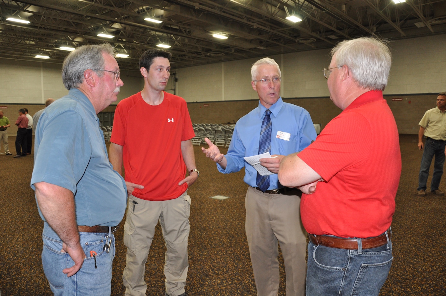 FARGO, N.D. -- Kevin Bluhm, planning, second from the right, discusses the Fargo, N.D./ Moorhead, Minn., Metropolitan Area Flood Risk Management Project with area citizens during a public meeting in Fargo June 25.