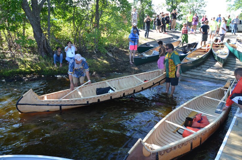 MCGREGOR, Minn. -- Members of the St. Croix Ojibwe Tribe launch their hand-made birchbark canoes at Big Sandy Lake, near McGregor, Minn., July 31. About 200 people gathered to remember the more than 400 Anishinaabe people that died during the winter of 1850-1851.
