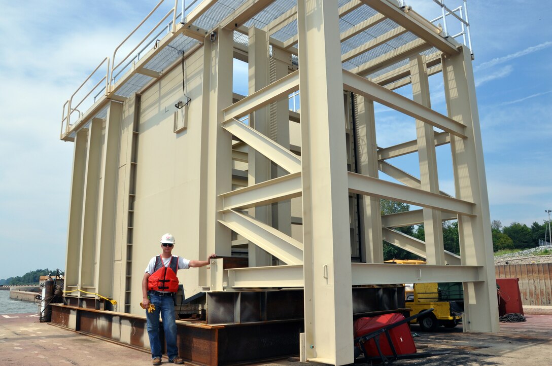Project engineer Keith Fleck stands with the special dewatering box that was designed by Engineering Division and built by the Louisville Repair Station to repair the sills of the last wicket dams on the Ohio River at locks and dams 52 and 53. The customized mini-cofferdam is scheduled to be inaugurated in September on the Chanoine wicket sills at Locks and Dam 52. The 42.5-ton steel box will cover three wicket sills, and once pumped clear, will allow work to be down in dry conditions. Because of their deteriorated condition, repairs to both 52 and 53 are more frequent to keep them functioning until the Olmsted Locks and Dam replacement project becomes operational in 2020.