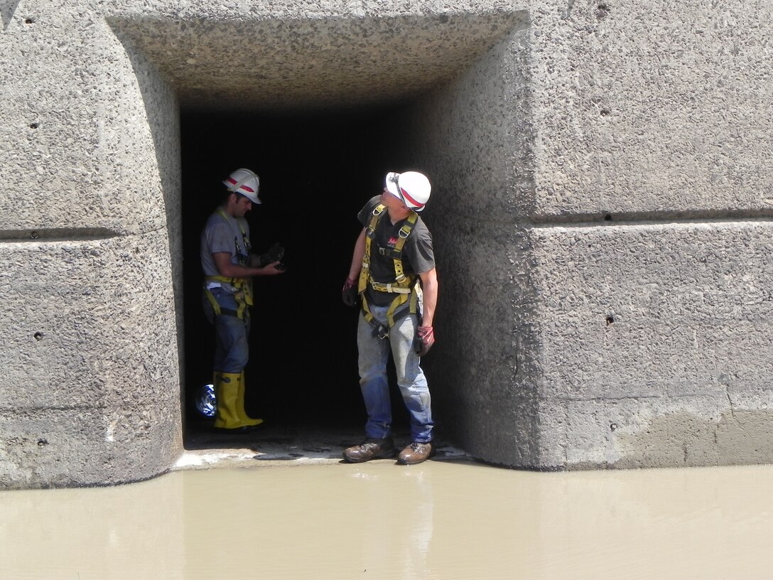 for the first time anyone can remember, the U.S. Army Corps of Engineers Buffalo District constructed a dirt coffer dam to divert the Genesee River through three open gates while they performed inspections inside six de-watered conduits, August 26, 2013.

Conduits are the tunnels beneath the dam through which the river passes. For this inspection, we were interested in the condition of the concrete conduits, the steel gates and all associated components.

