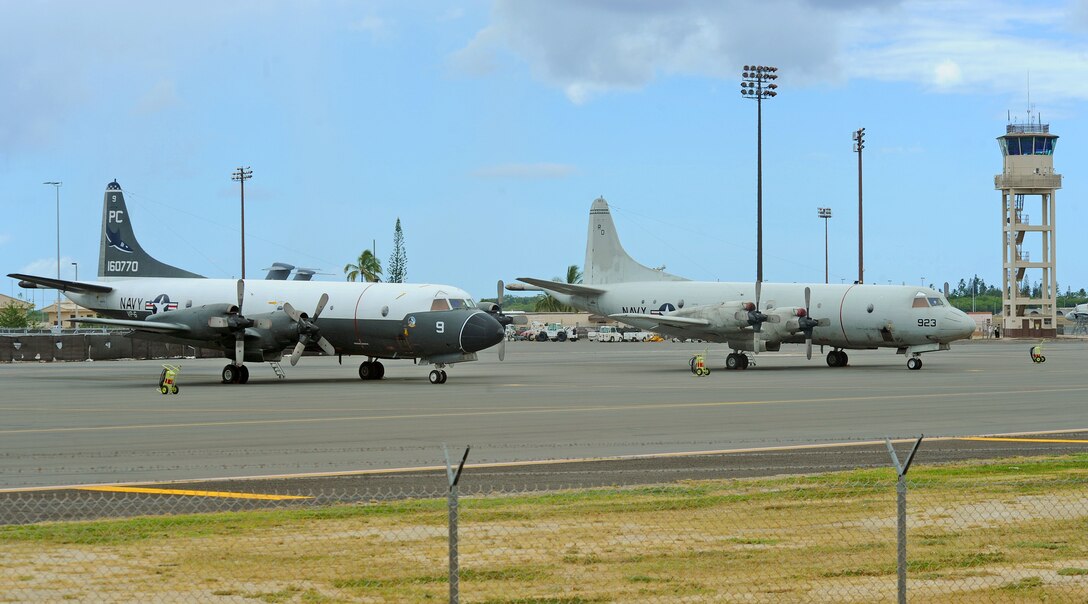 A pair of Navy P-3C Orion aircraft sit parked on the flightline at Joint Base Pearl Harbor-Hickam, Hawaii, Sept. 3, 2013. The aircraft are assigned to Patrol Squadron NINE at Marine Corps Base Hawaii, which will operate temporarily out of JBPH-H while the MCBH runway undergoes renovations. During the 60-day renovation, the unit will continue to perform its primary mission of anti-submarine warfare, anti-surface warfare and intelligence, surveillance and reconnaissance. (U.S. Air Force photo/Tech. Sgt. Jerome S. Tayborn) 