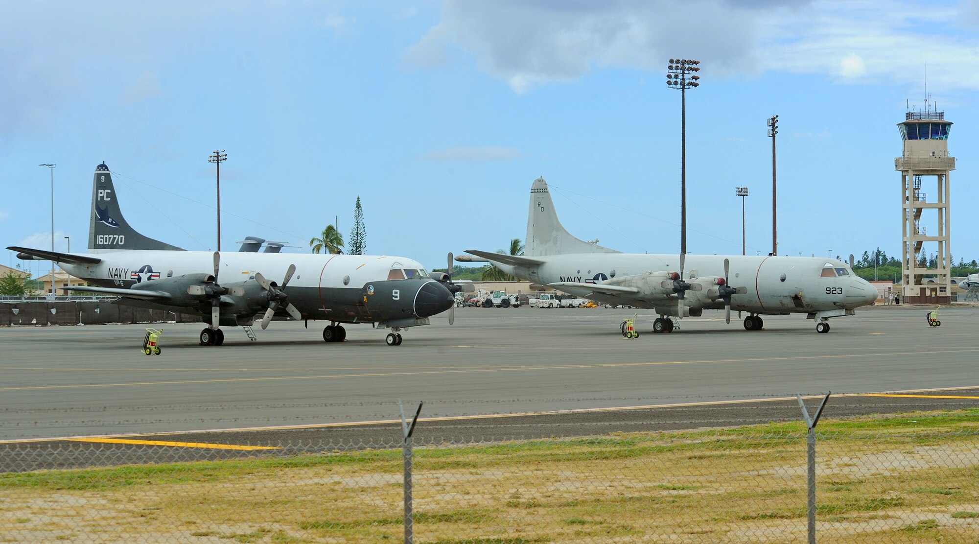A pair of Navy P-3C Orion aircraft sit parked on the flightline at Joint Base Pearl Harbor-Hickam, Hawaii, Sept. 3, 2013. The aircraft are assigned to Patrol Squadron NINE at Marine Corps Base Hawaii, which will operate temporarily out of JBPH-H while the MCBH runway undergoes renovations. During the 60-day renovation, the unit will continue to perform its primary mission of anti-submarine warfare, anti-surface warfare and intelligence, surveillance and reconnaissance. (U.S. Air Force photo/Tech. Sgt. Jerome S. Tayborn) 