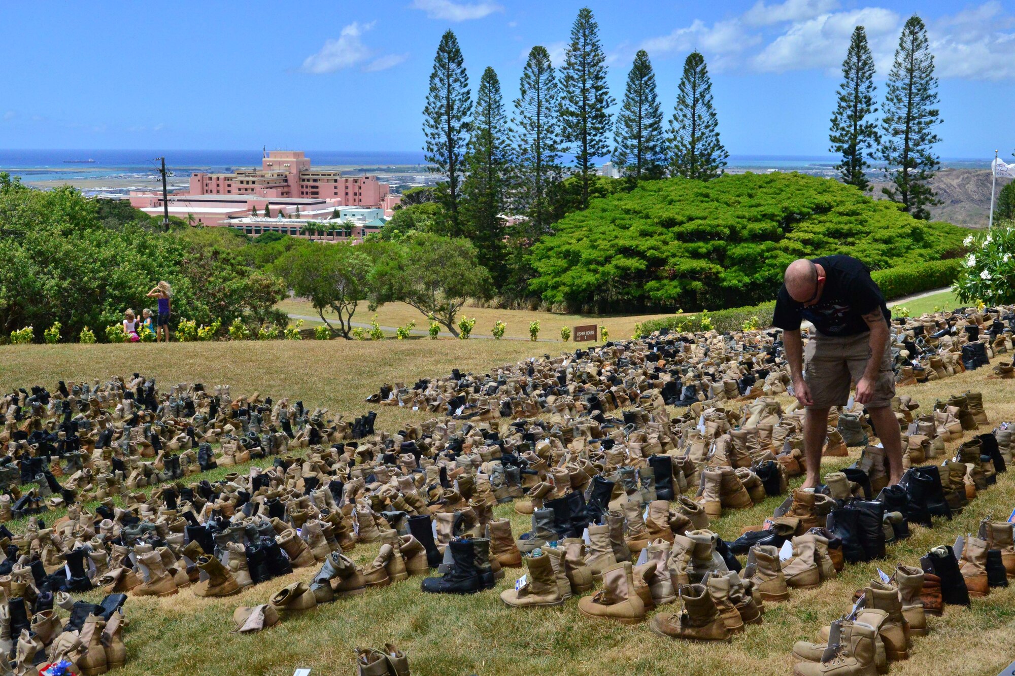 A Fisher House volunteer looks for boots to tag and lace Sept. 1, 2013. More than 4,000 boots were tagged and donated as part of the Fisher House Hero and Remembrance Run, slated for Sept. 7. The event, scheduled to be held on Ford Island, drew more than 5,000 attendees last year to remember the service members who gave the ultimate sacrifice during Operations Enduring Freedom, Iraqi Freedom and New Dawn. More than 2,500 boots are still needed for the event. For more information about Fisher House or the run, contact Theresa Johnson at (808) 433-1291. (U.S. Air Force photo by Senior Airman Christopher Stoltz)