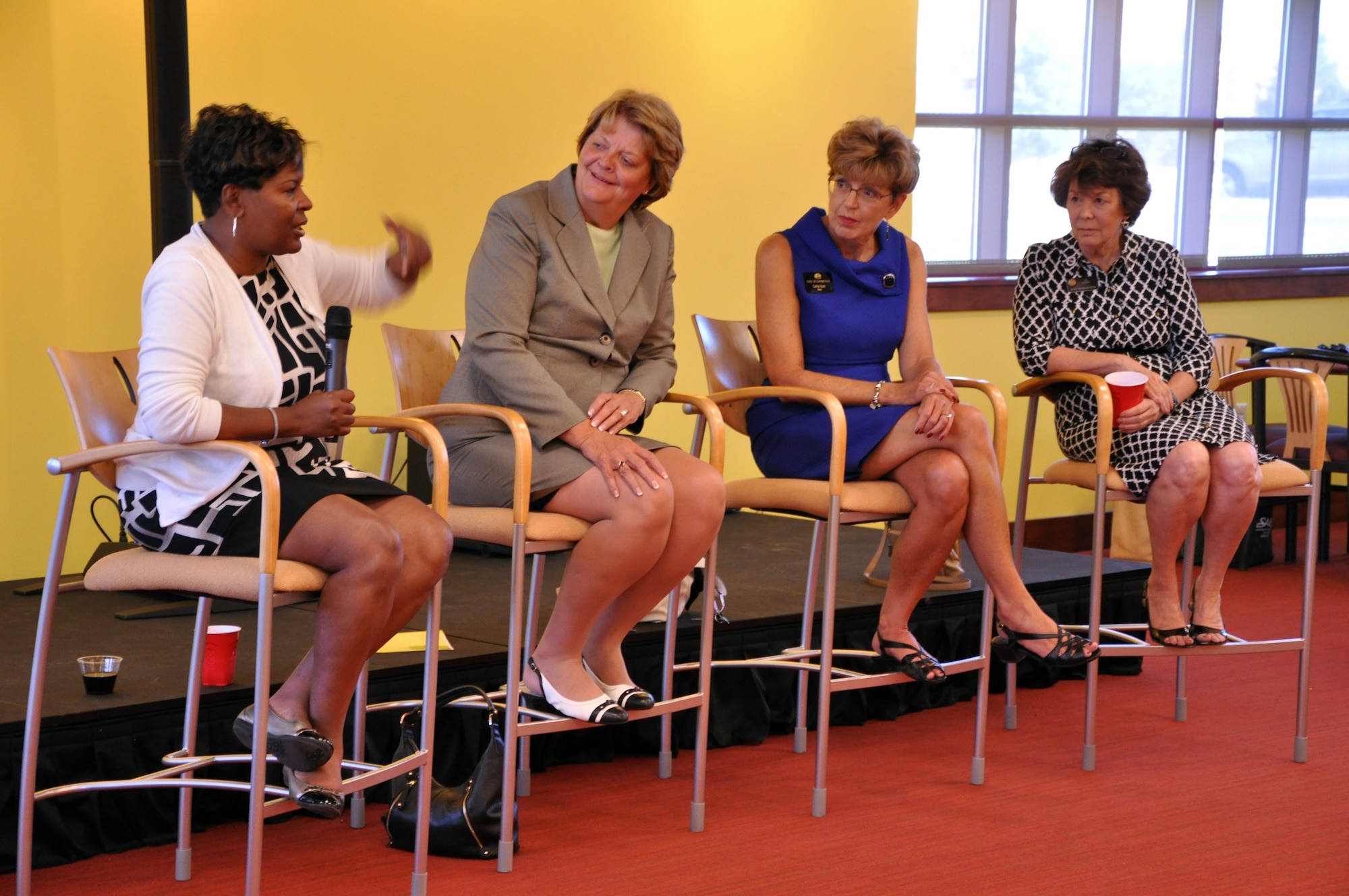 Lisa Buckley, Chair of Command Information on the Aurora Defense Council, speaks at the Women's Professional Panel as Mary Chelsey, Cathy Noon and Su Ryden listen on Aug. 28 at the Panther Den on Buckley Air Force Base, Colo. The Women's Professional Panel was an opportunity for local professional women to offer life and career advice. (U.S. Air Force photo by Staff Sgt. Sabrina Moore/Released)